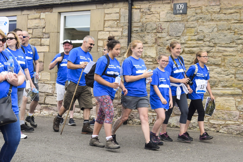 Group of people wearing Butterfly Trust t-shirts setting out on a charity walk to fundraise for the Butterfly Trust.
